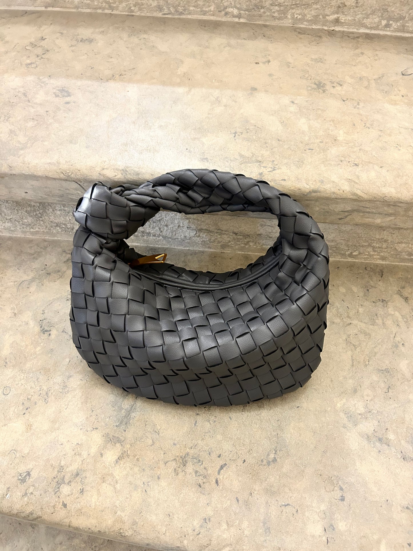 Modern woven clutch bag with structured silhouette