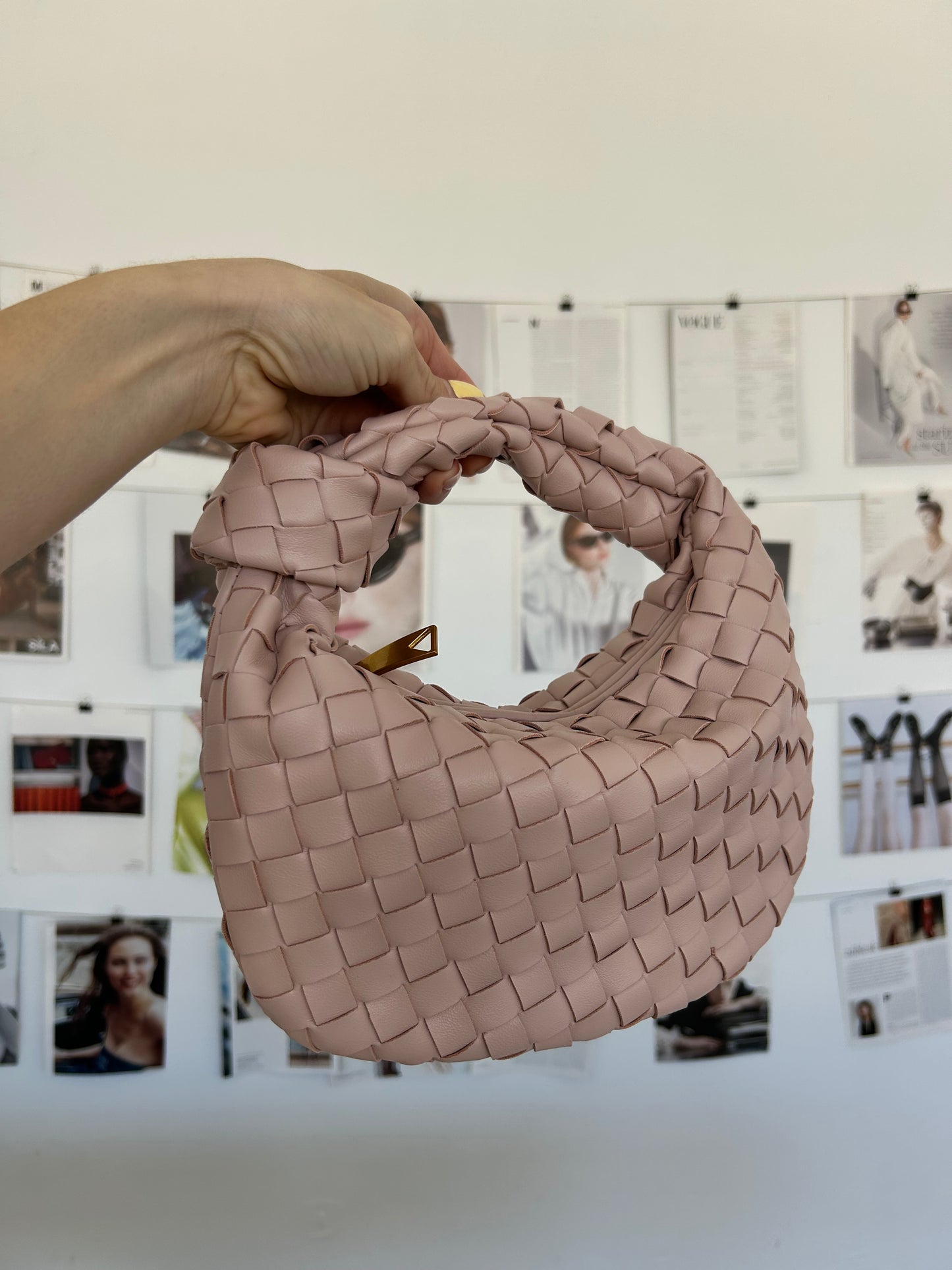Blush pink designer-inspired woven clutch bag in vegan leather, trendy romantic accessory styled by influencers. bottega veneta dupe bag