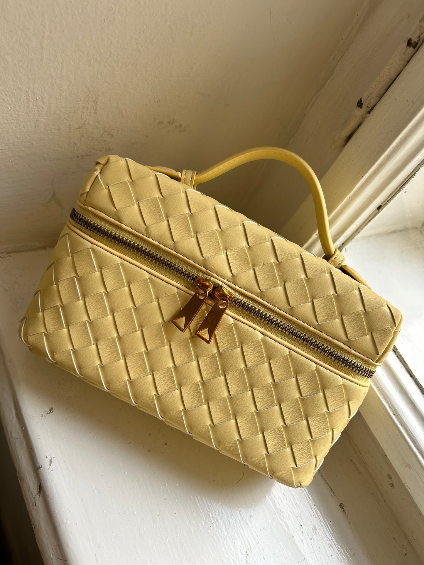 Relaxed but refined, the boxy interwoven purse is designed for women who want style without compromise. The slouchy shape pairs beautifully with the woven finish, offering a polished look that's as practical as it is pretty. Designer inspired handbag with triangle zip