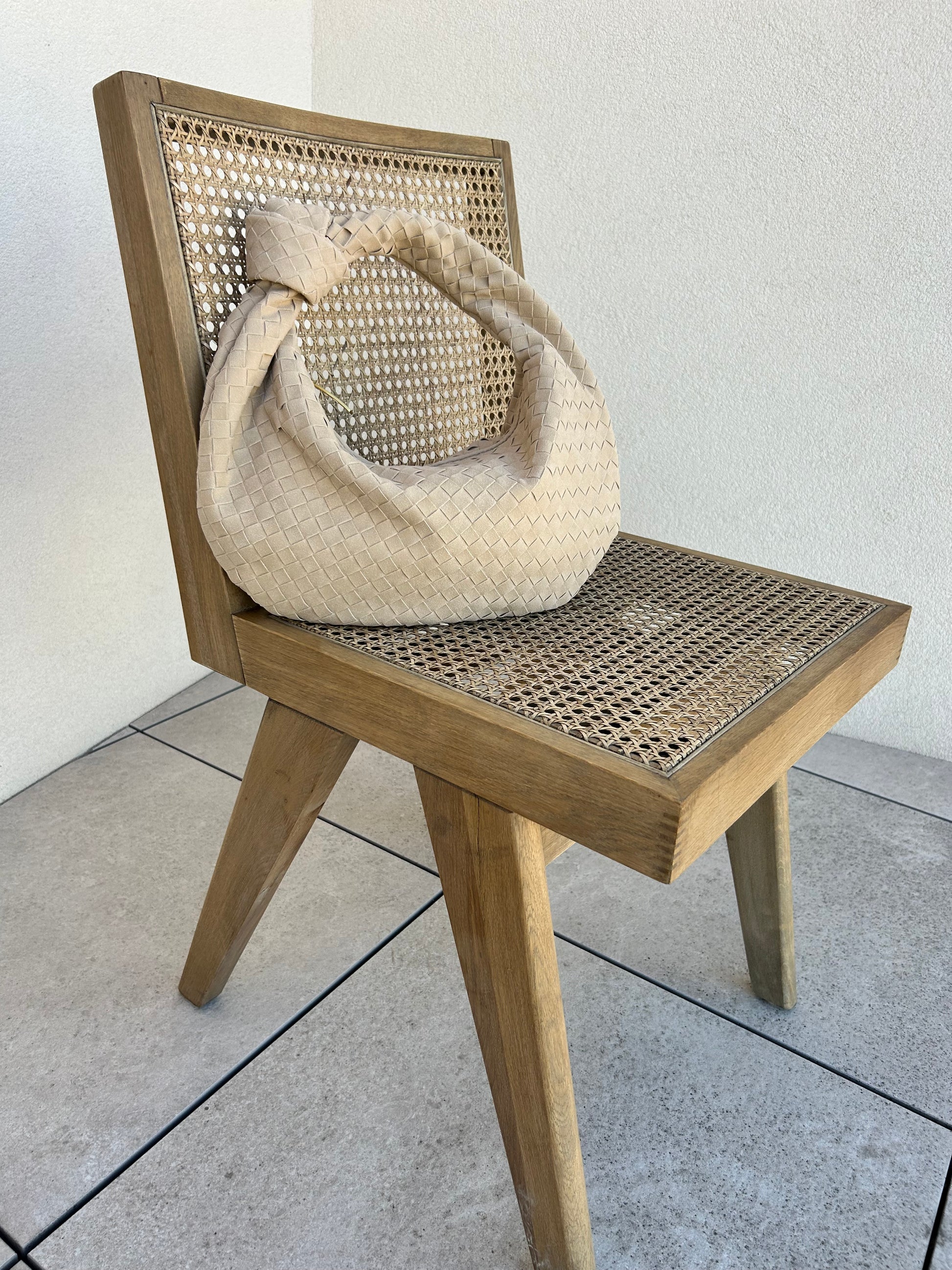 This trendy woven bag is perfect for a night out or summer holiday! Made from luxurious beige suede, this hobo clutch features a stylish zipper closure for added security. designer inspired bag birthday gift shoulder tote pattybofficial dupe bag. Premium designer style handbag placed on a chair to create a casual aesthetic photo