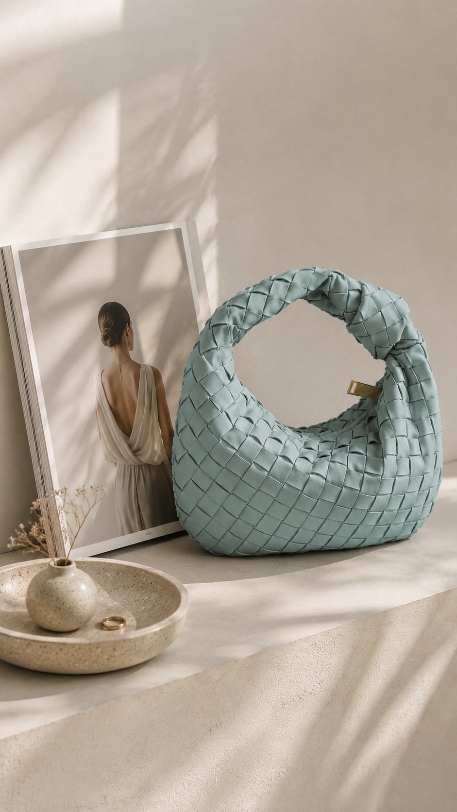 Baby blue woven hand-held clutch made from premium vegan leather with elegant gold zip detail.