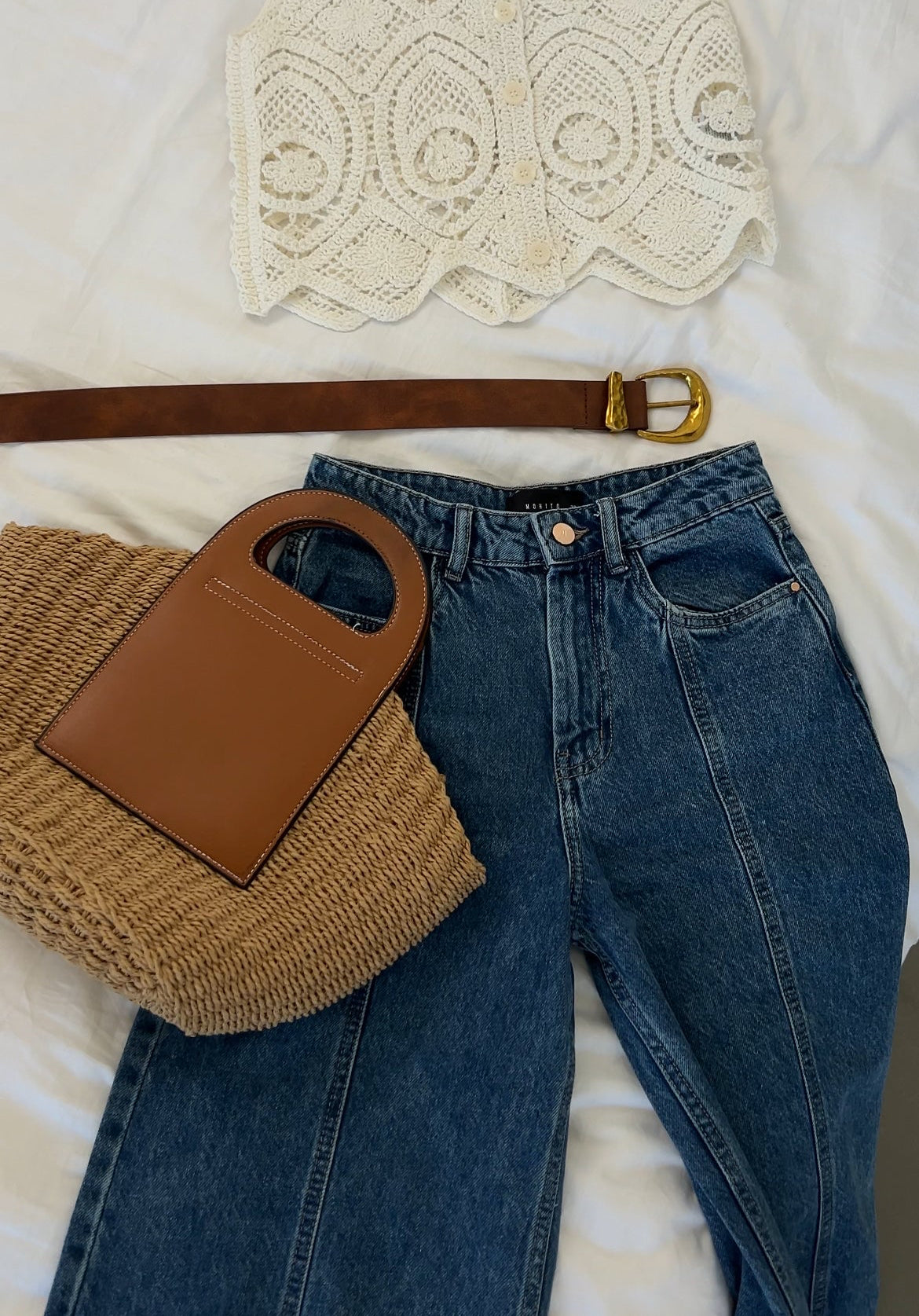 Beach style woven bag with vegan leather handle styled with denim outfit