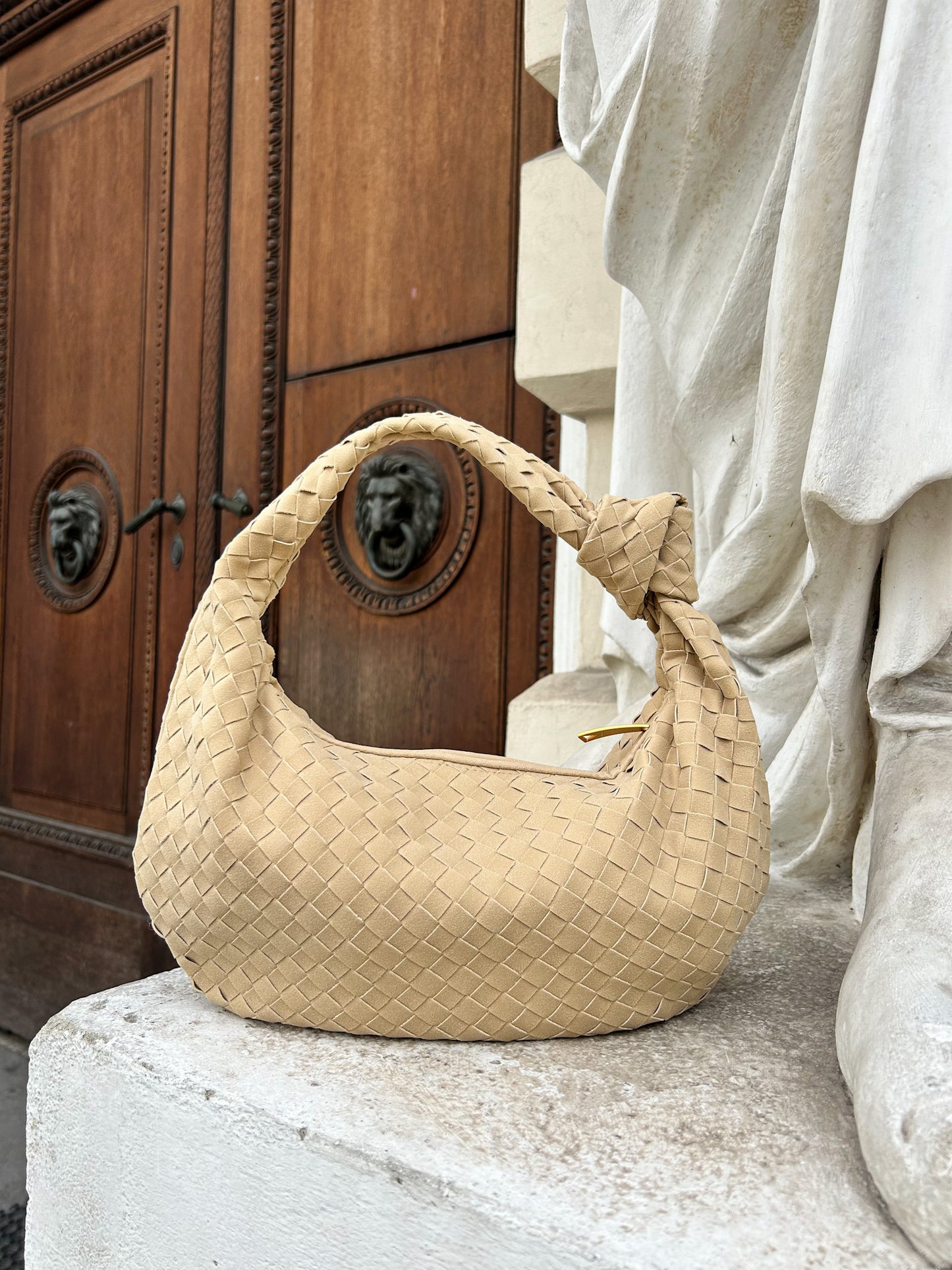 Introducing our exquisite and luxurious Suede Clutch for wedding, a stunning accessory that will elevate any outfit with its elegance and sophistication. This woven Dumpling Bag is crafted from high-quality vegan leather. Designer inspired dupe bag