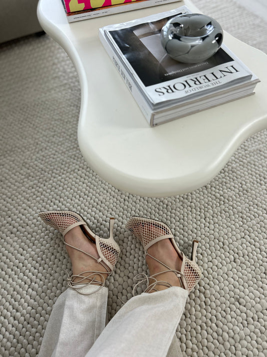 Beige lace-up sandals made from vegan leather styled with neutral outfit