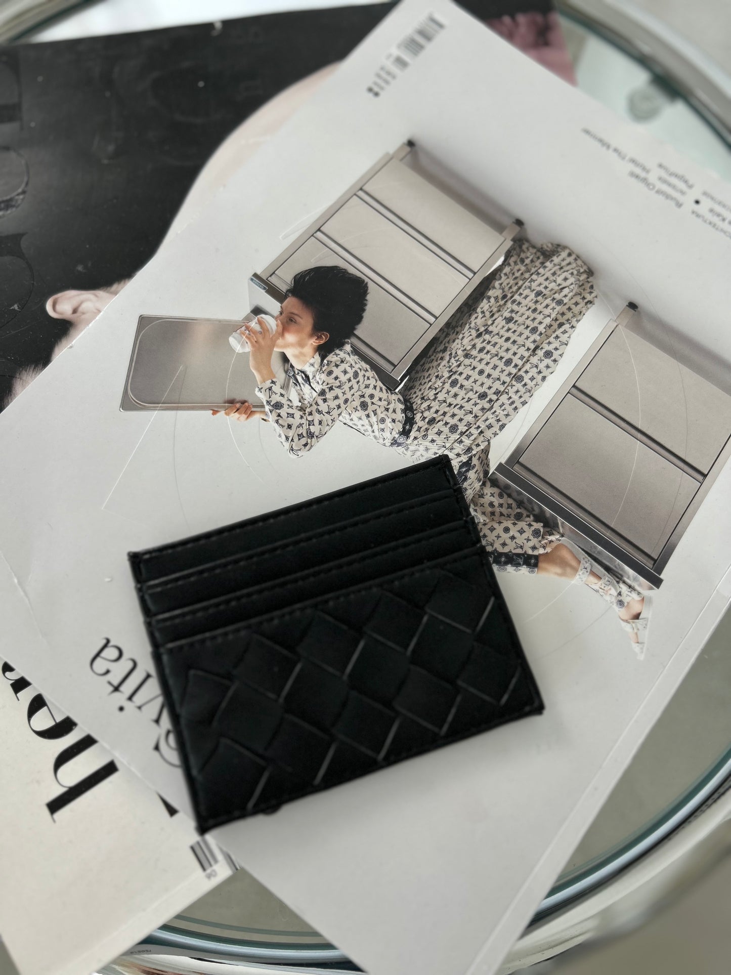 Black vegan leather cardholder with minimalist design on lifestyle background