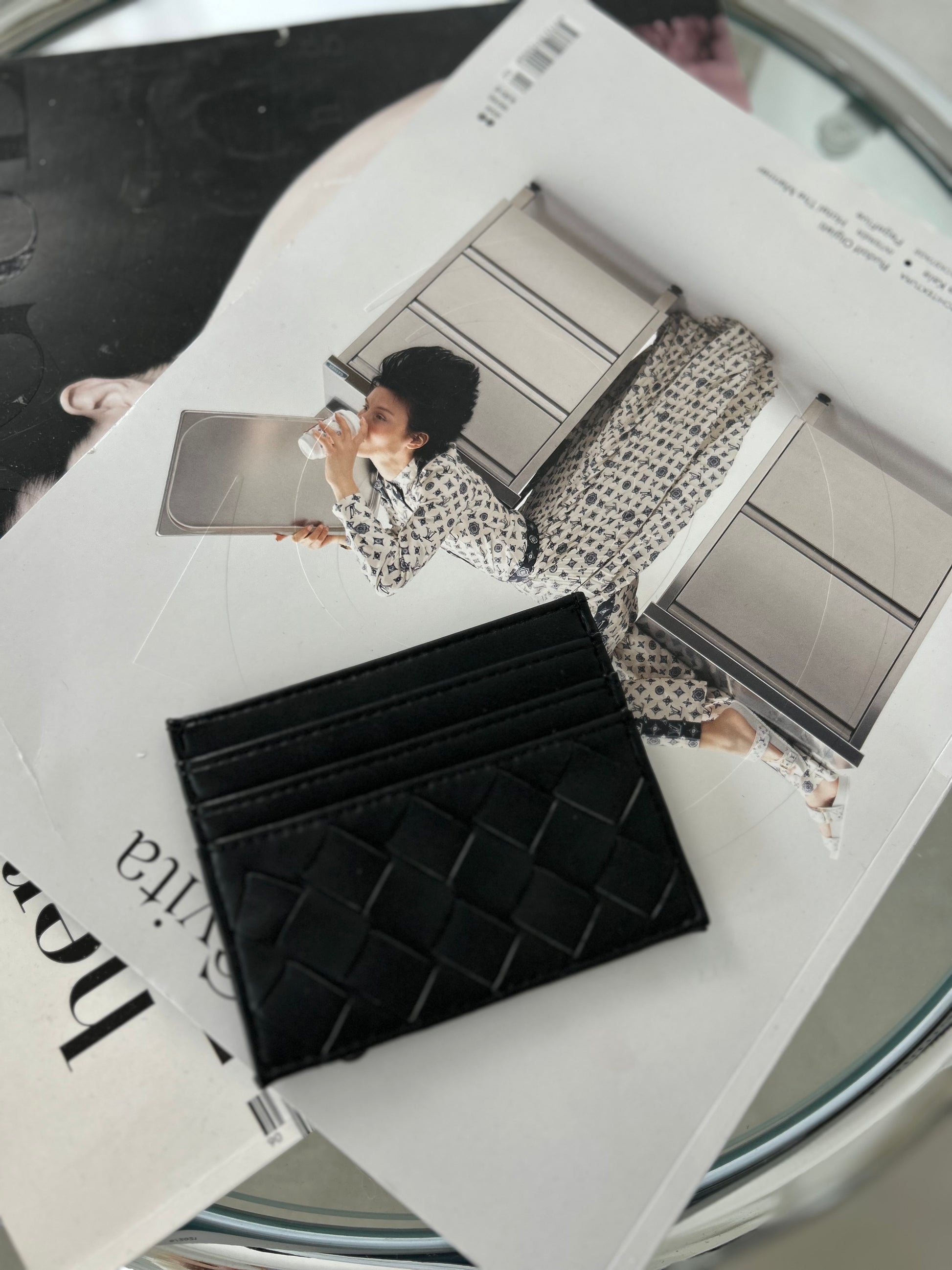 Black vegan leather cardholder with minimalist design on lifestyle background