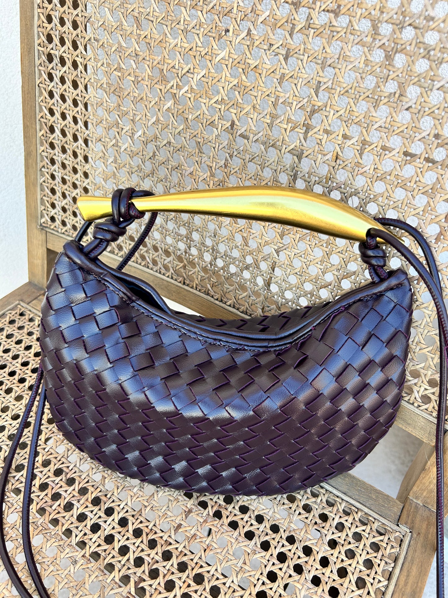 Burgundy-brown clutch with unique gold handle detail
