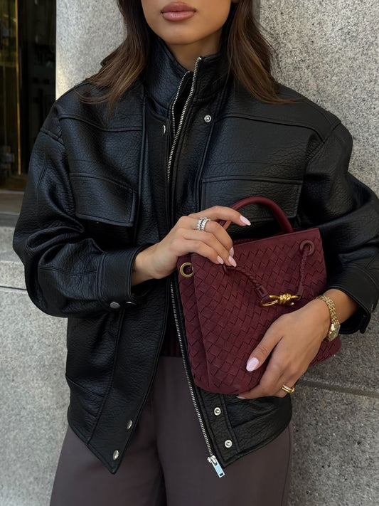 Burgundy vegan suede convertible bag worn crossbody with leather jacket