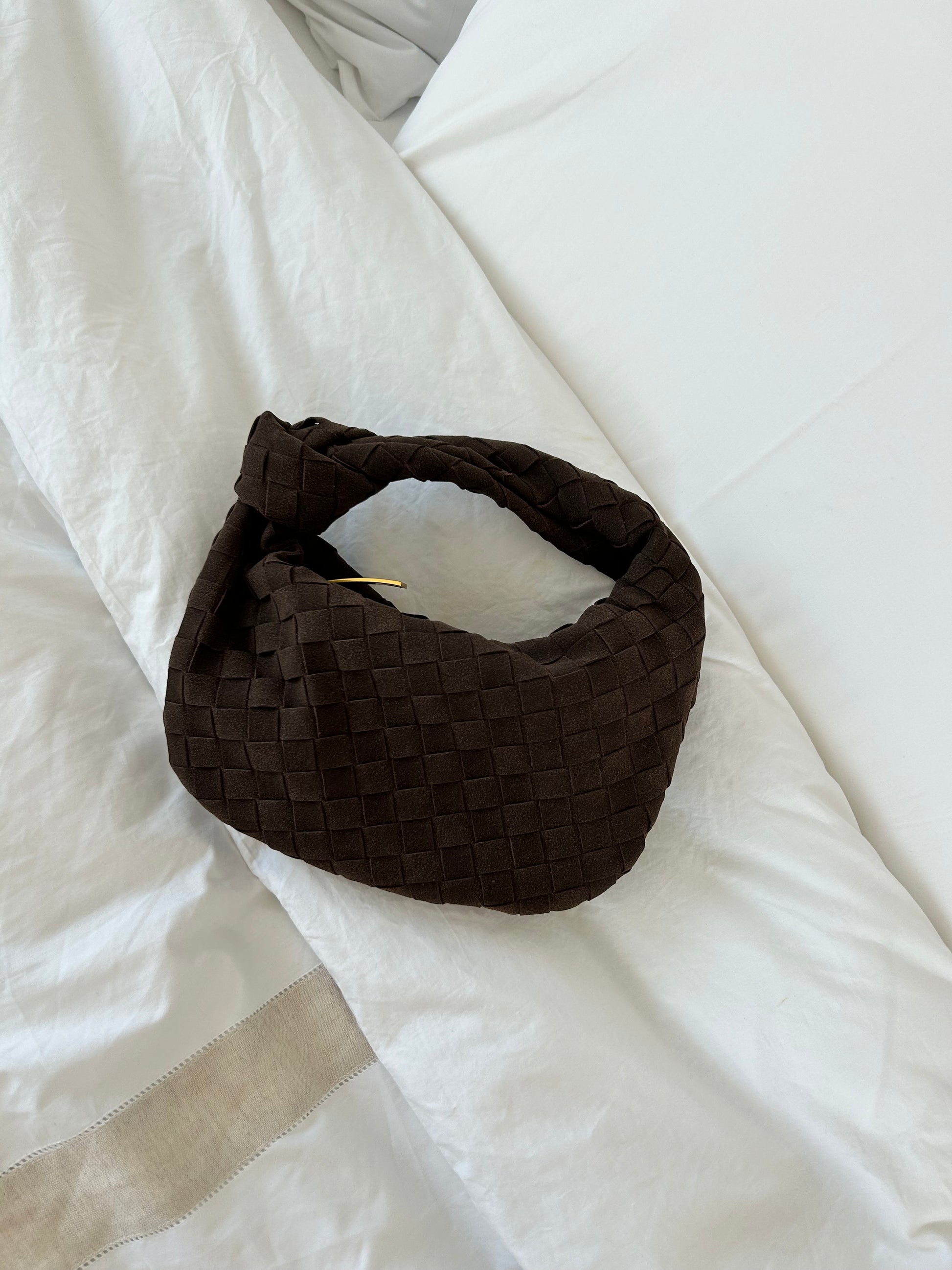 Close-up of plush teddy texture on vegan suede clutch