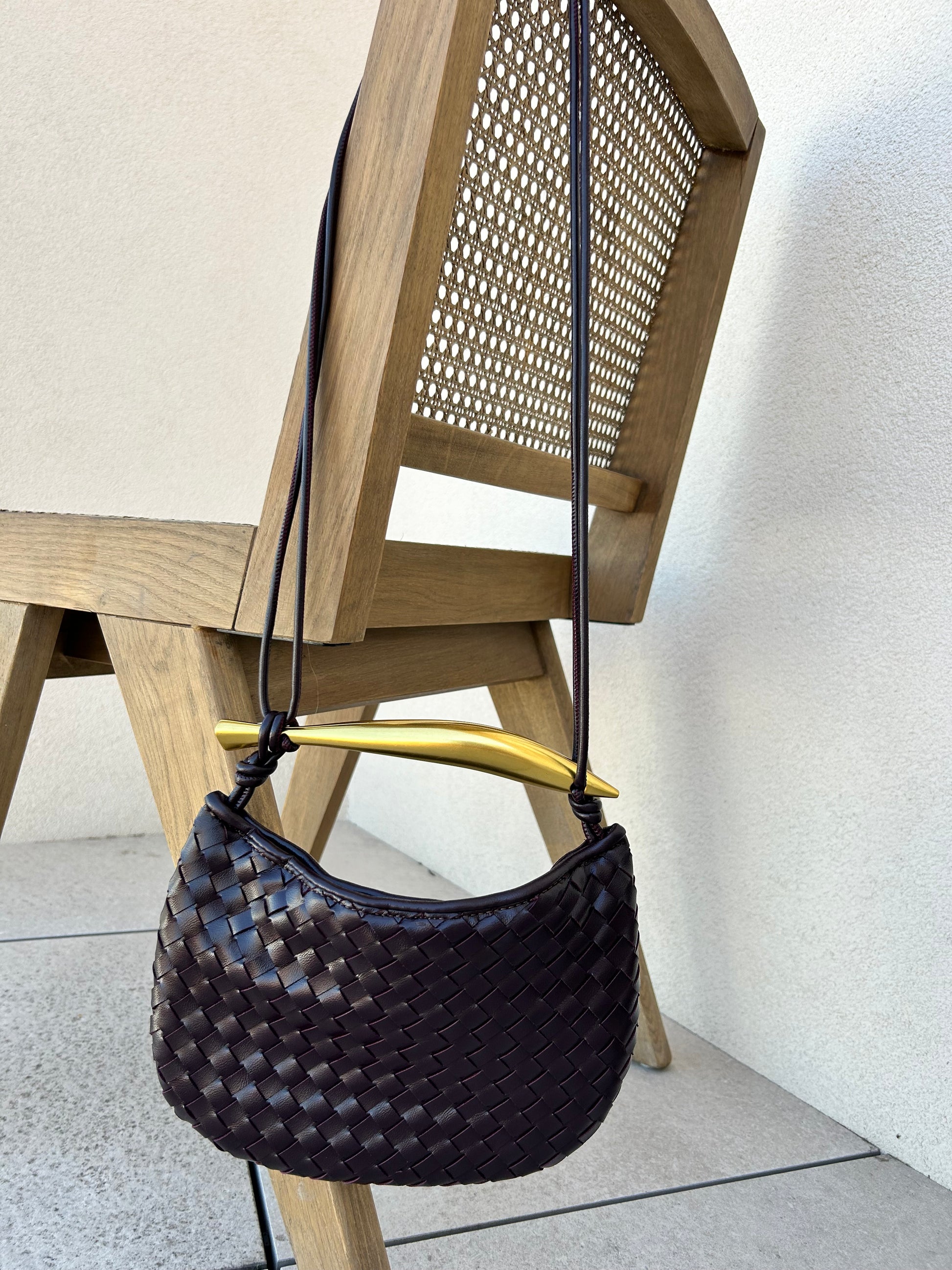 Convertible clutch bag worn crossbody with minimalist outfit