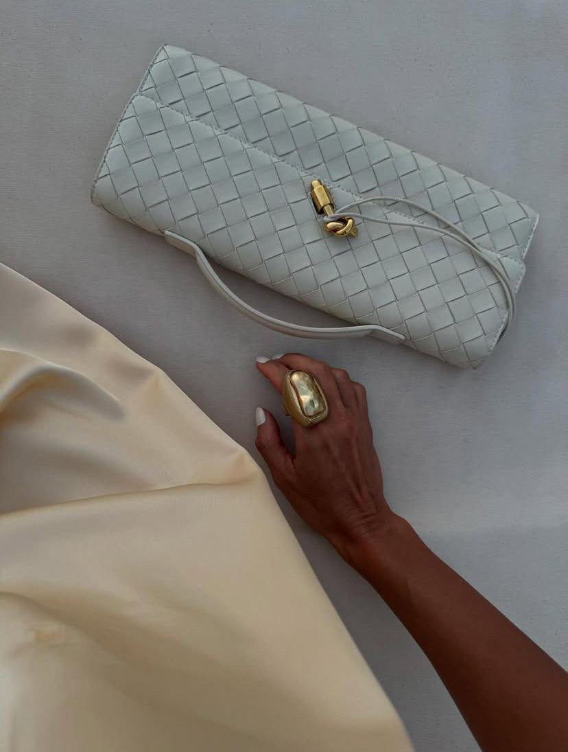 Cream woven crossbody clutch made from premium vegan leather with gold hardware