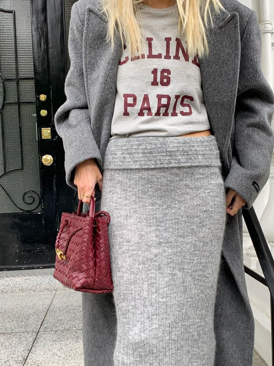 Dark red vegan leather woven bag with gold hardware, elegant designer-inspired PattyB handbag styled in a chic winter outfit