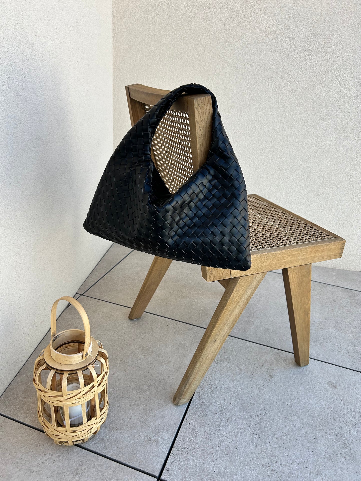 Designer-inspired black woven handbag styled for everyday wear
