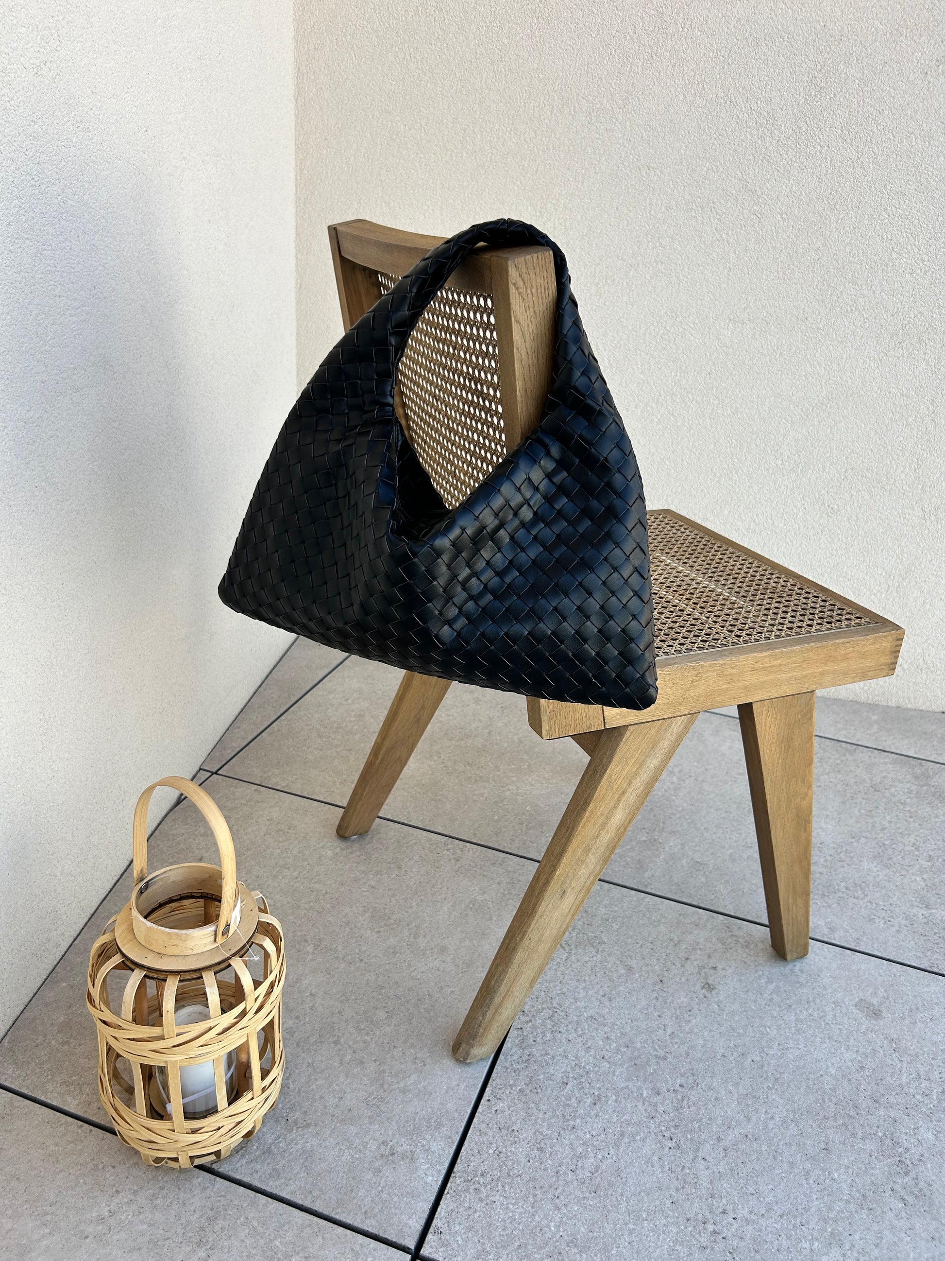 Designer-inspired black woven handbag styled for everyday wear