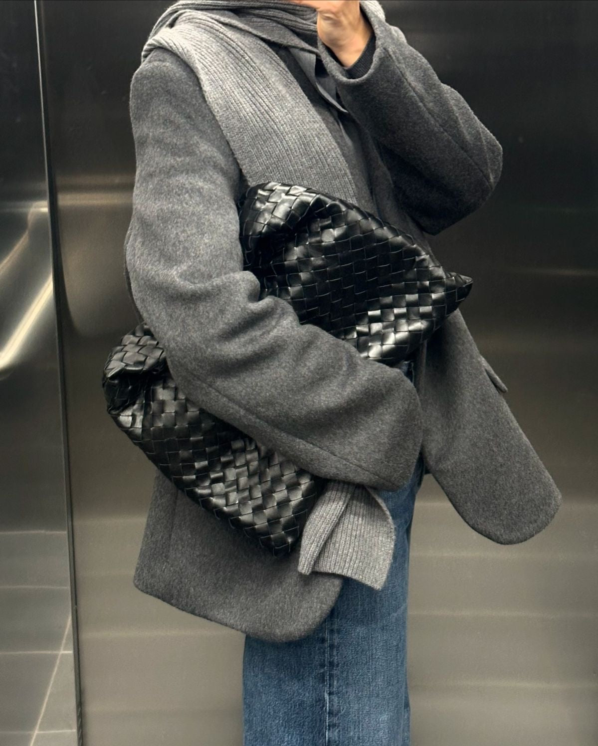 Designer-inspired black woven handbag styled for everyday wear