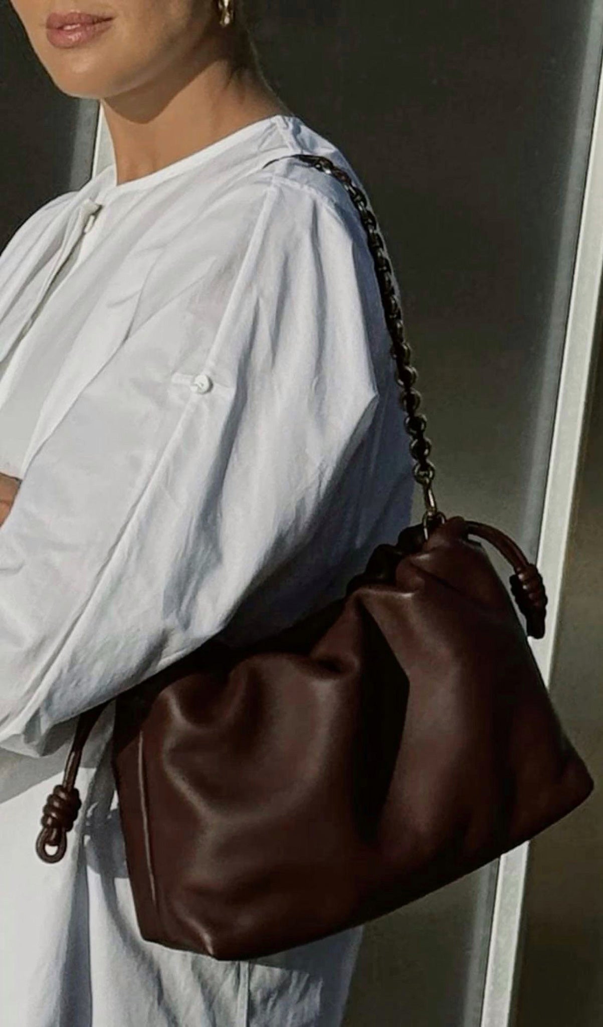 Designer-inspired dark brown soft clutch bag with detachable gold chain – timeless minimalist accessory.