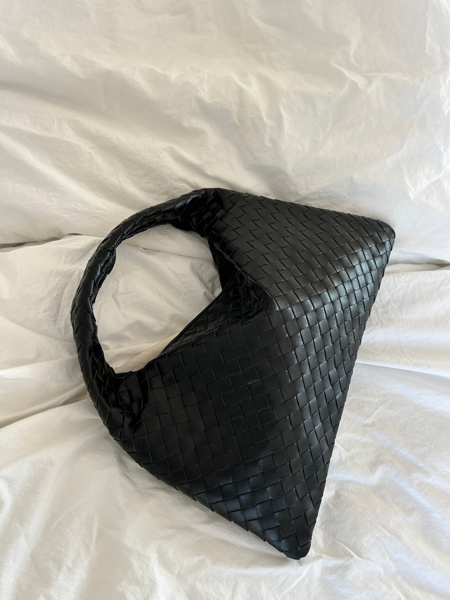 Elegant black shoulder bag with textured weave detail