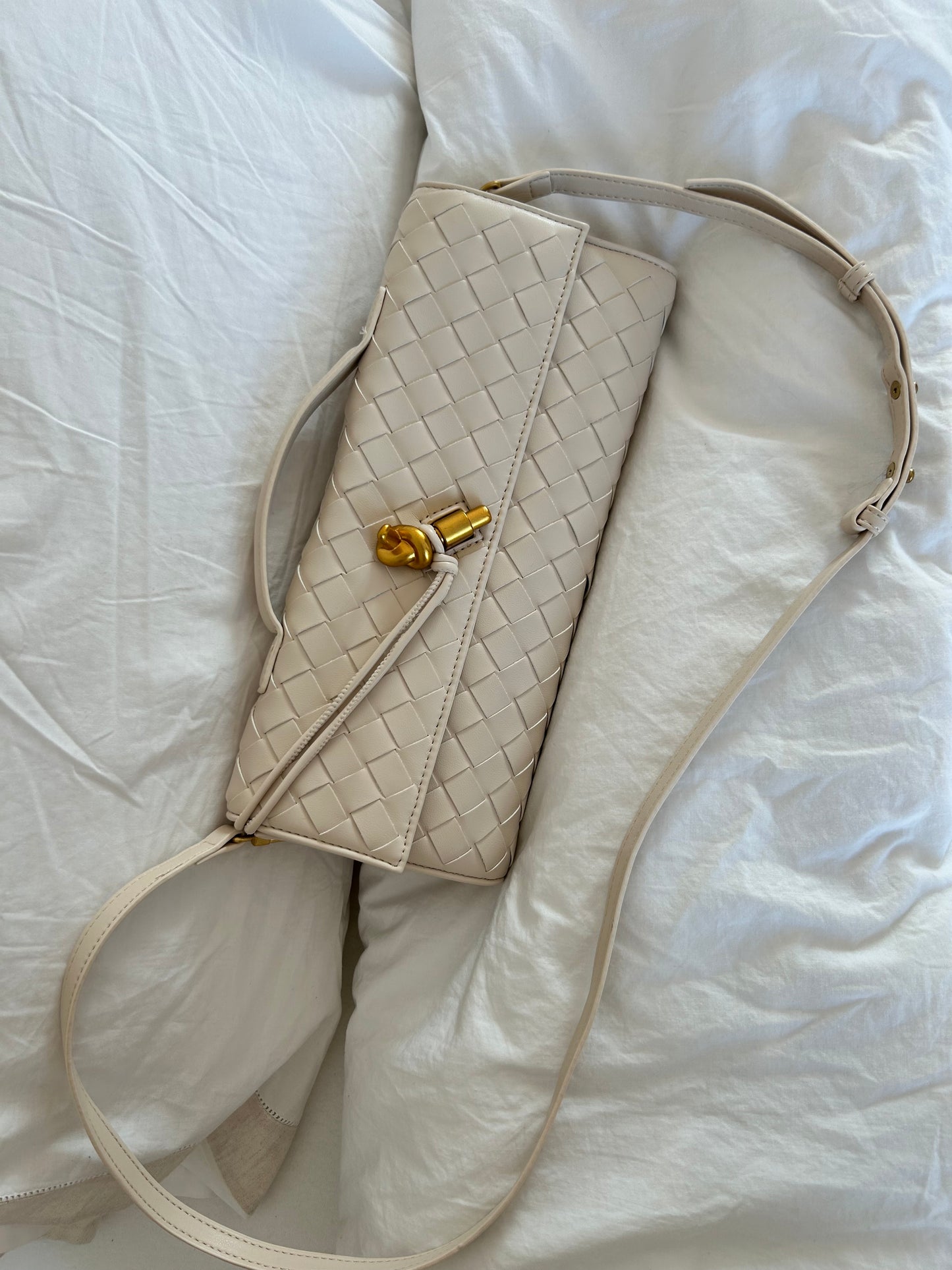 Elegant cream woven crossbody clutch crafted from premium vegan leather. Wear it as a clutch or crossbody bag for weddings, holidays, evenings and timeless everyday styling.