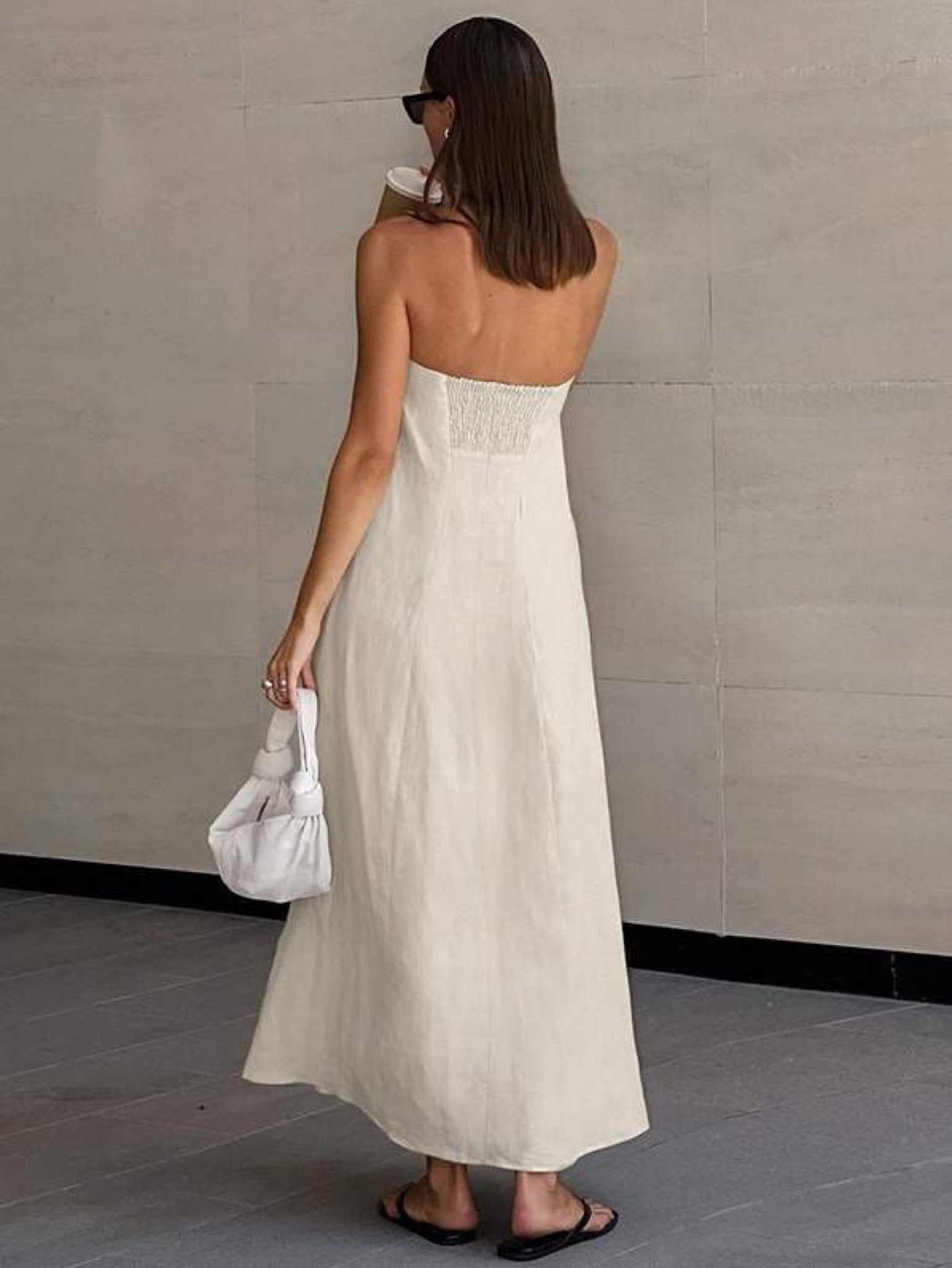 Elegant strapless linen maxi dress featuring hidden pockets. Perfect for holidays, beach vacations, city walks and timeless summer styling.
