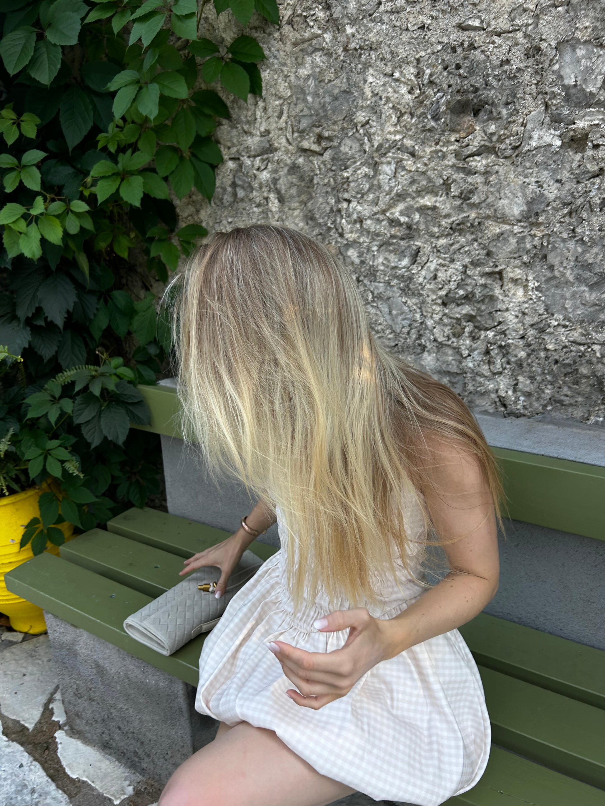 Elegant taupe clutch purse styled with a summer outfit.