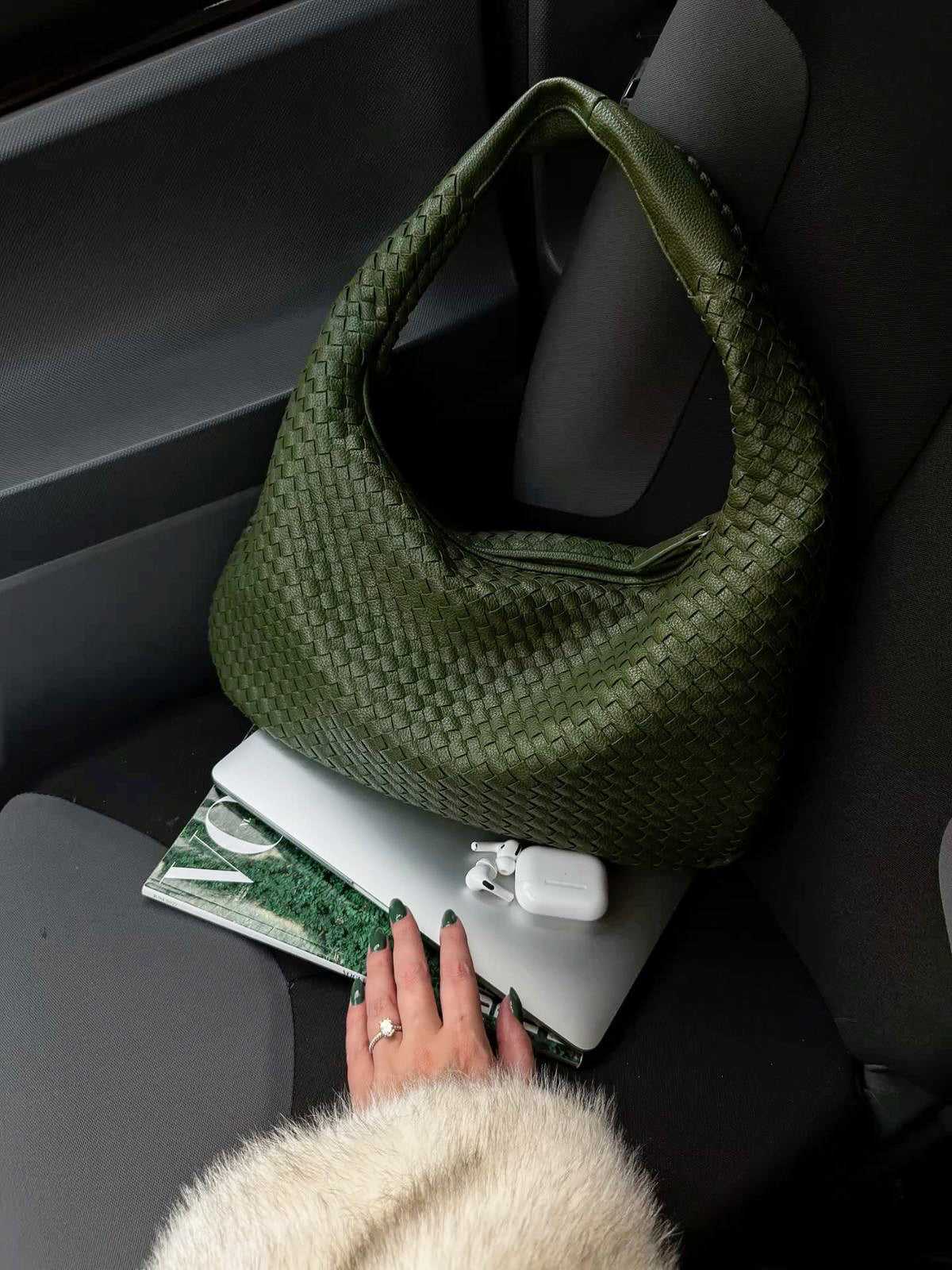 Everyday green hobo bag placed on chair in minimalist setting