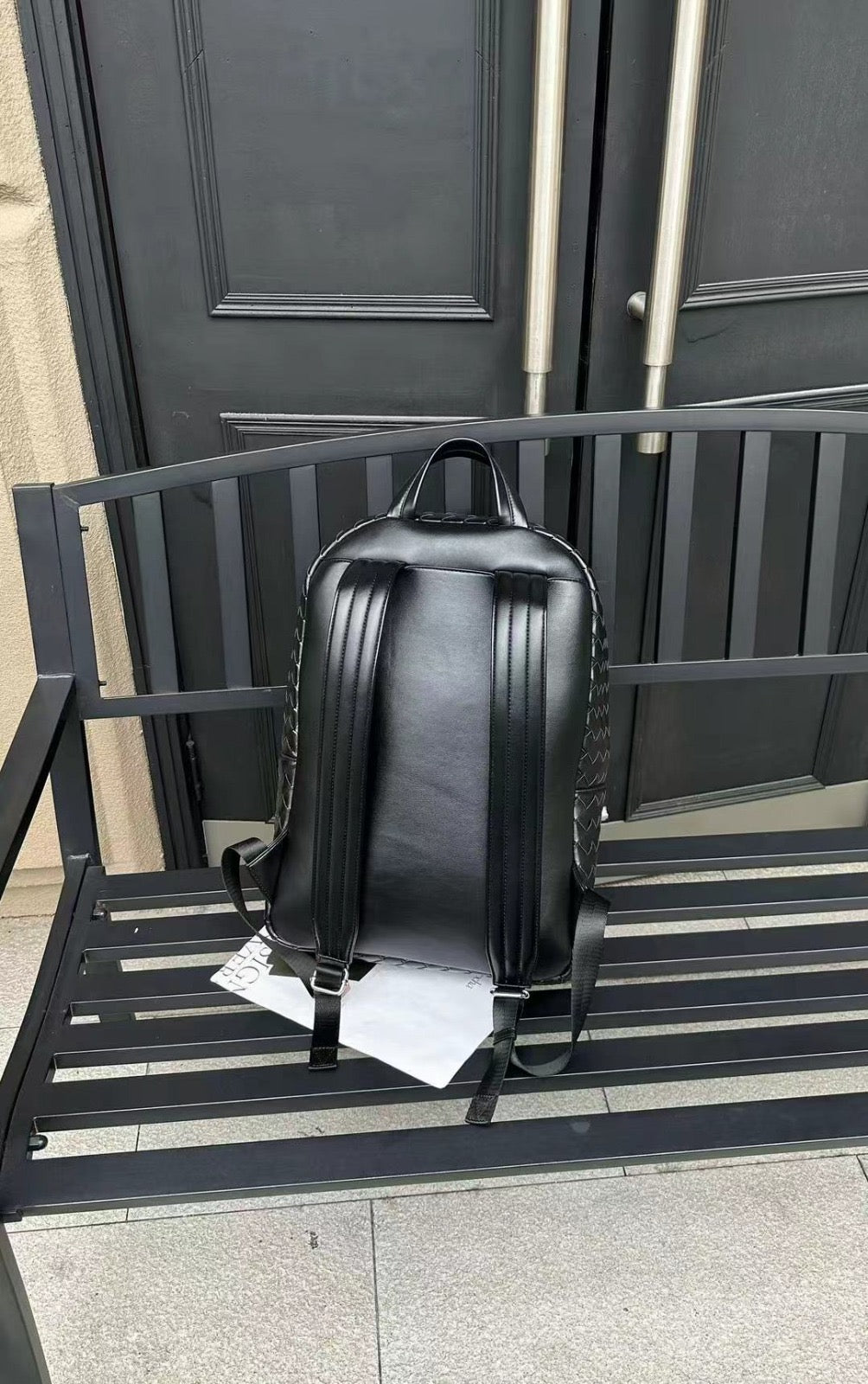 Luxury black genuine leather woven backpack with spacious interior and zip closure for daily essentials.