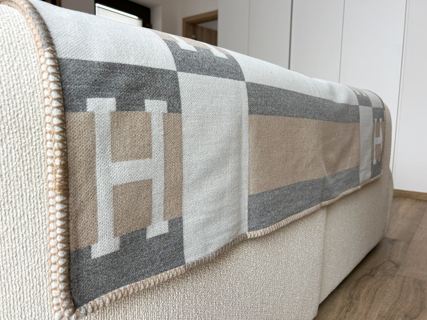 Minimalist home décor throw blanket with Scandinavian pattern in beige, grey and cream