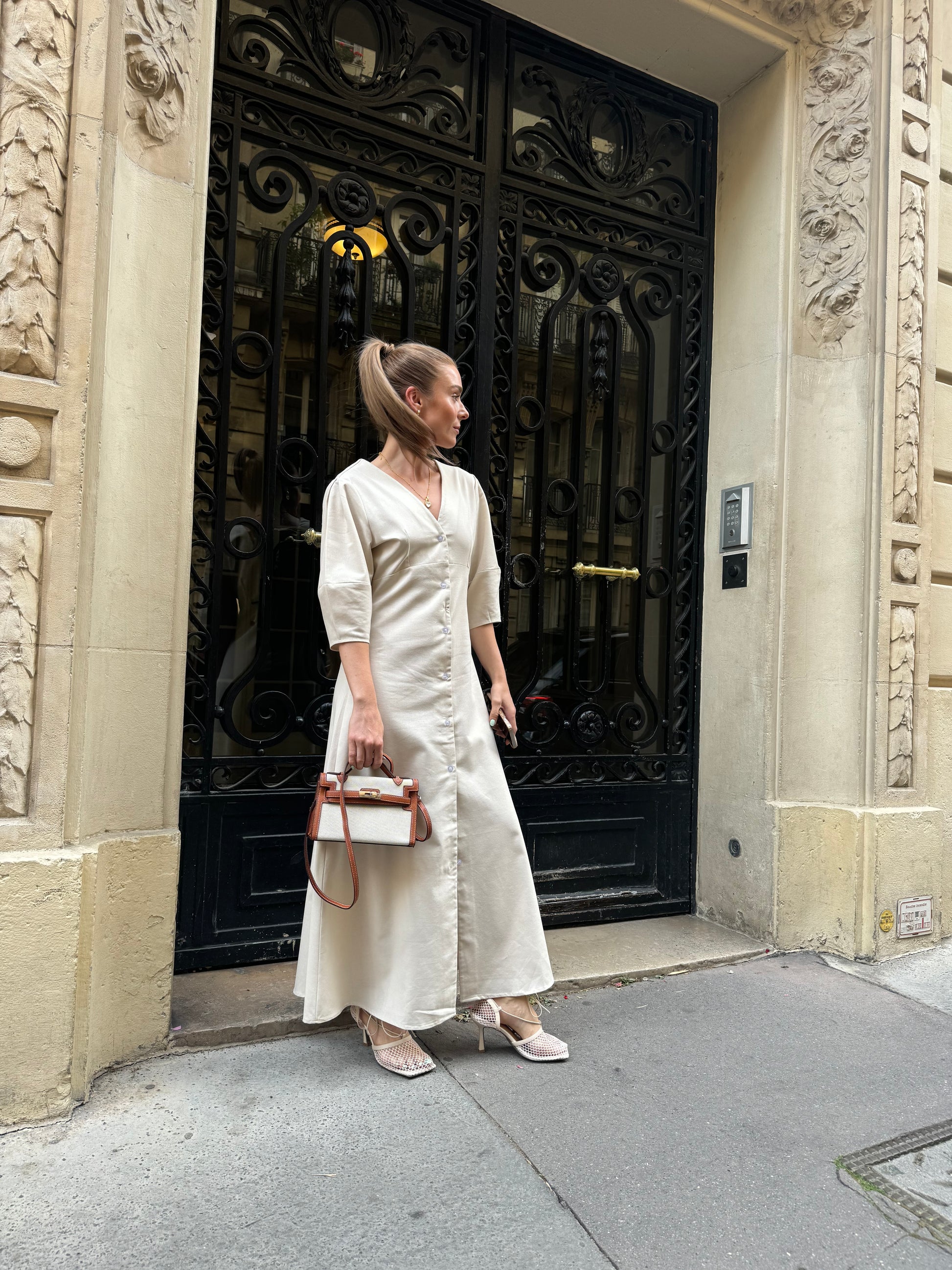 stylish woman wearing crossbody monochrome purse with detachable crossbody strap. 