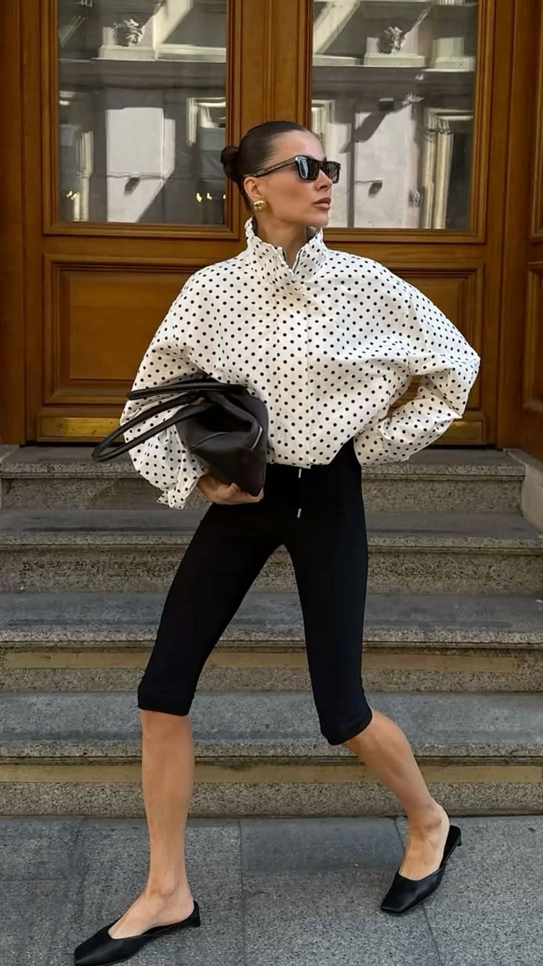 Street style outfit with polka dot bomber jacket and sunglasses city look.