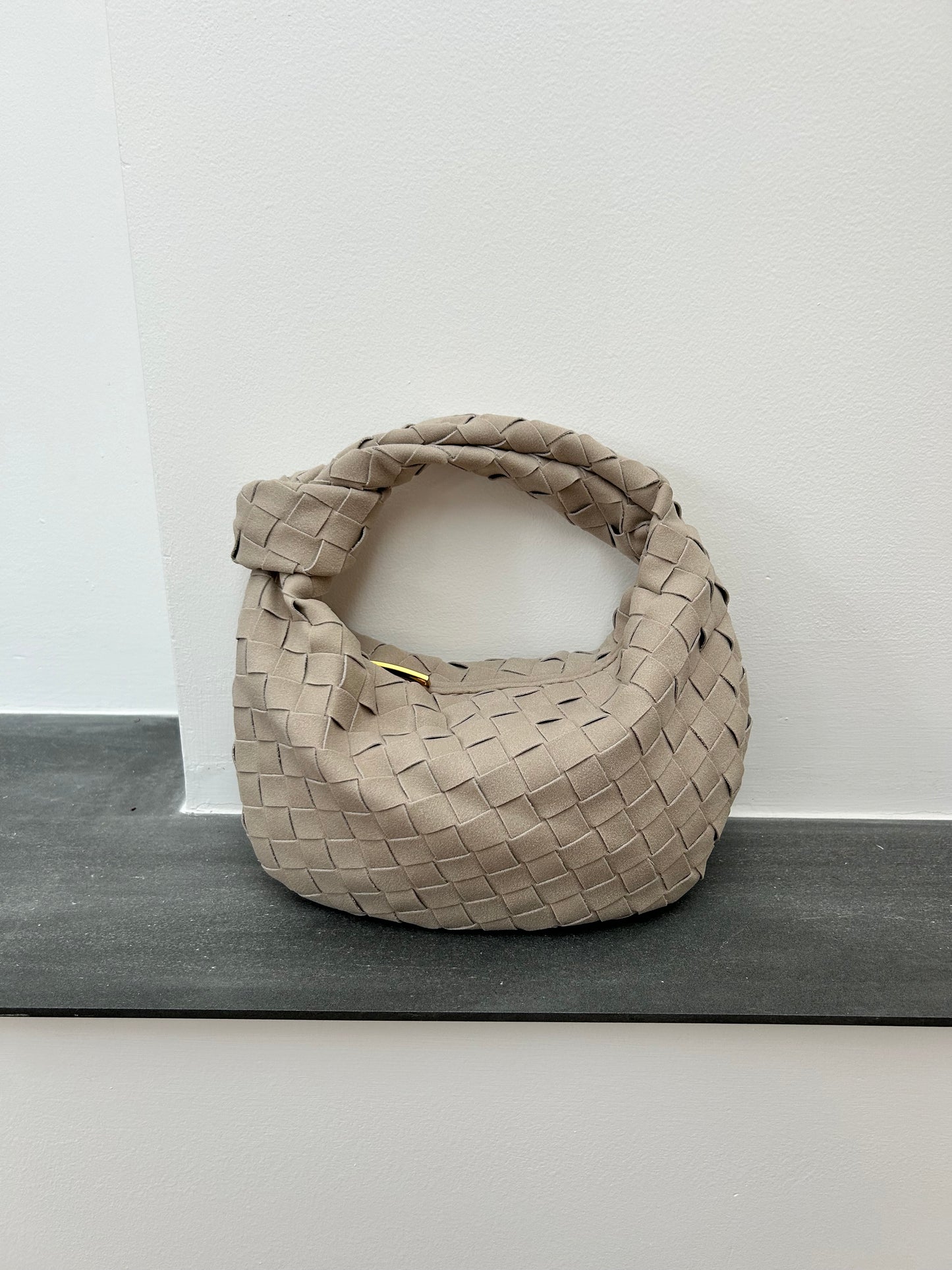 Taupe vegan suede clutch handbag close-up texture