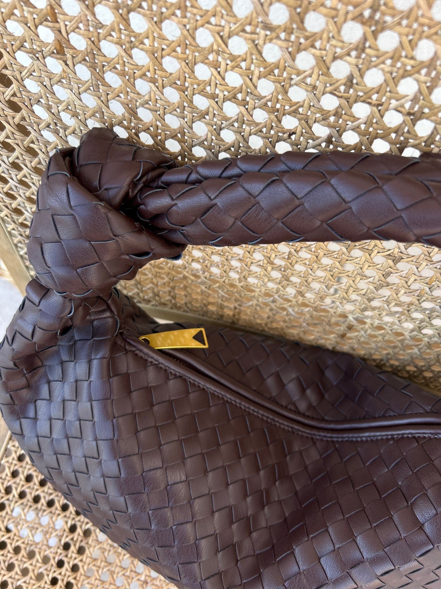 Woven texture detail on chocolate brown handbag