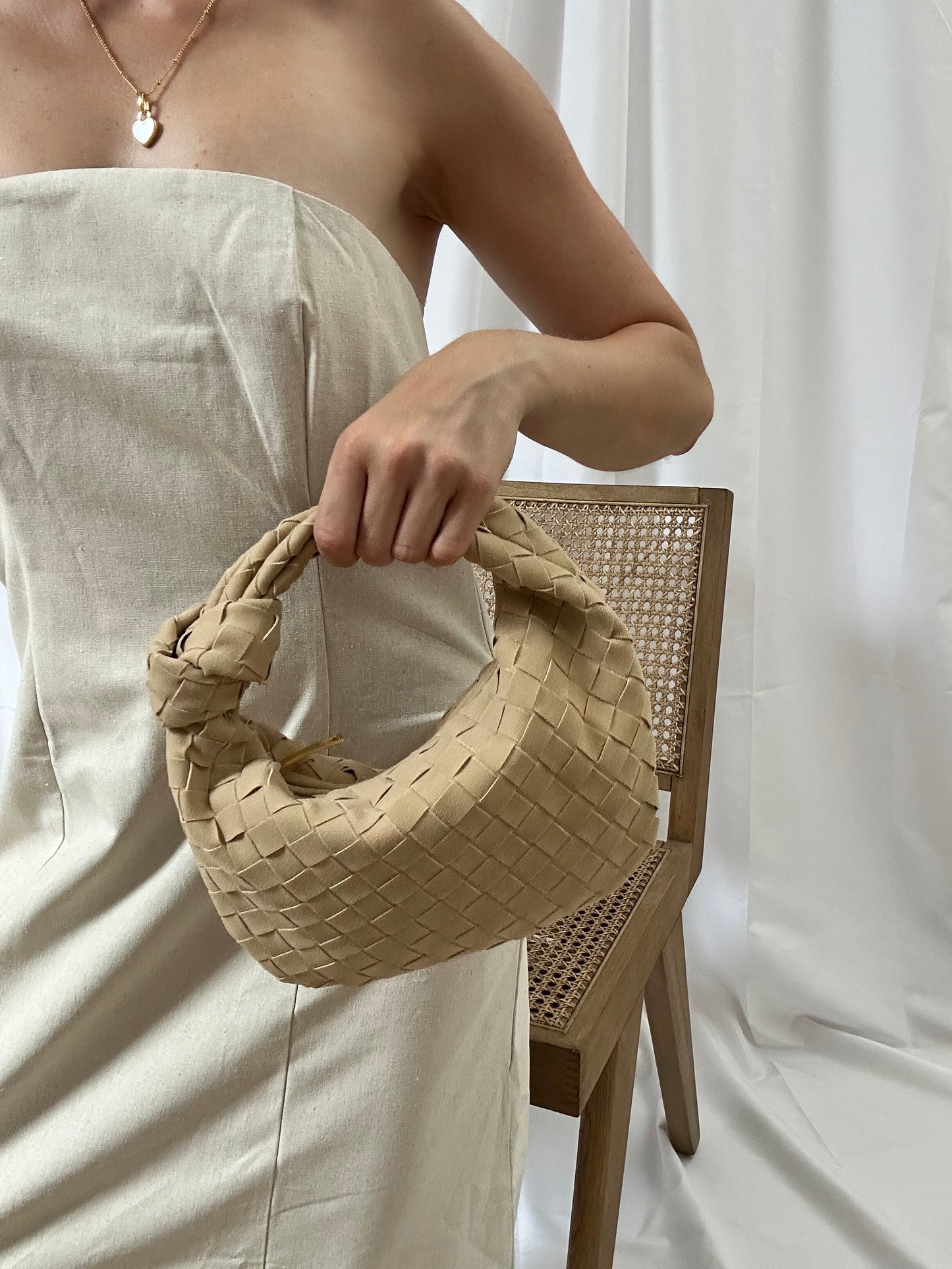 Outfit inspiration for stylish women including woven knot bag with top handle, matching heels and shorts. this designer inspired Purse for Women is Ideal Gift for Mom birthday. stylish vegan leather hobo bag for women who love minimalist fashion