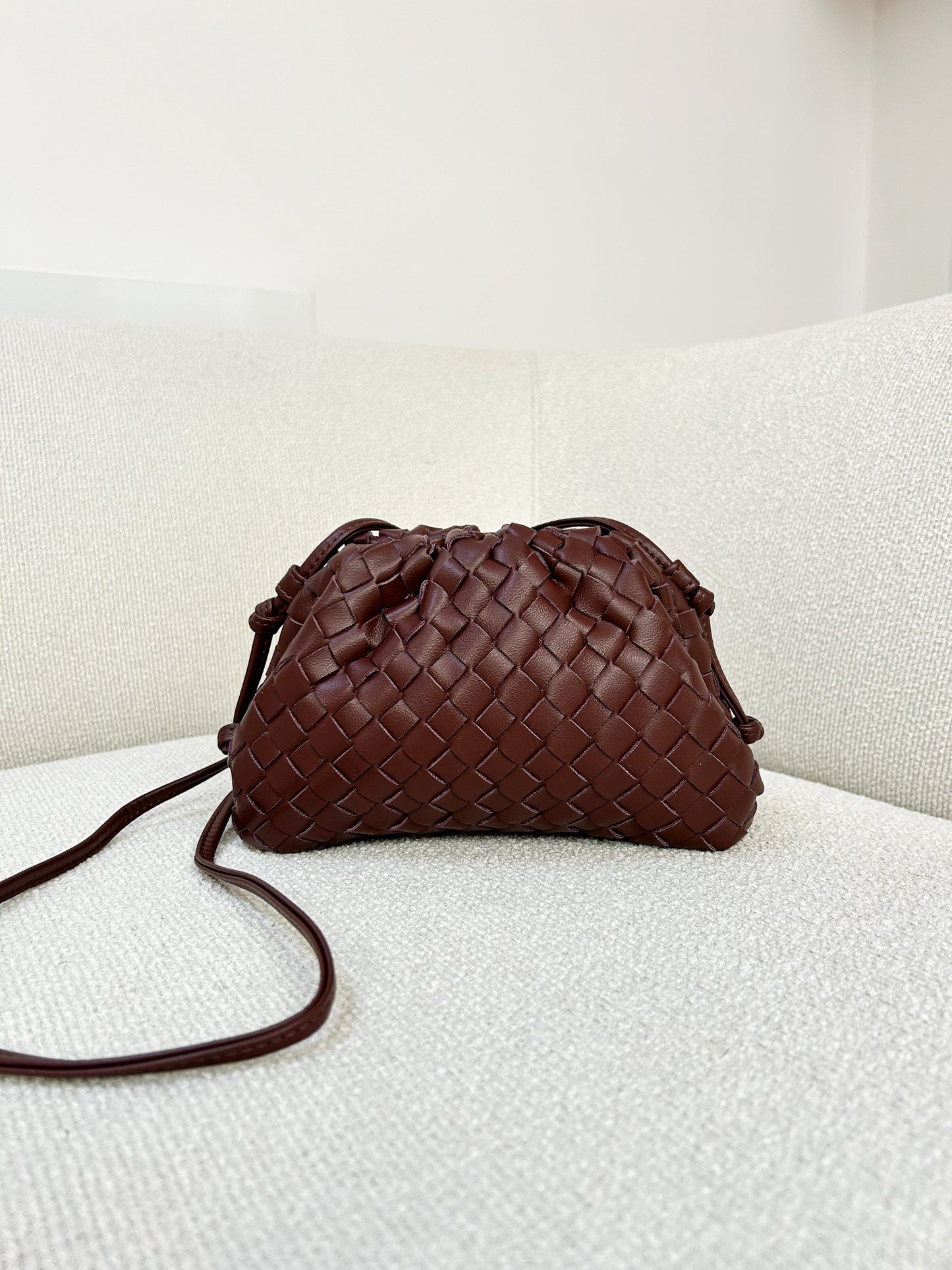 close-up woven vegan leather texture chocolate brown clutch bag premium finish