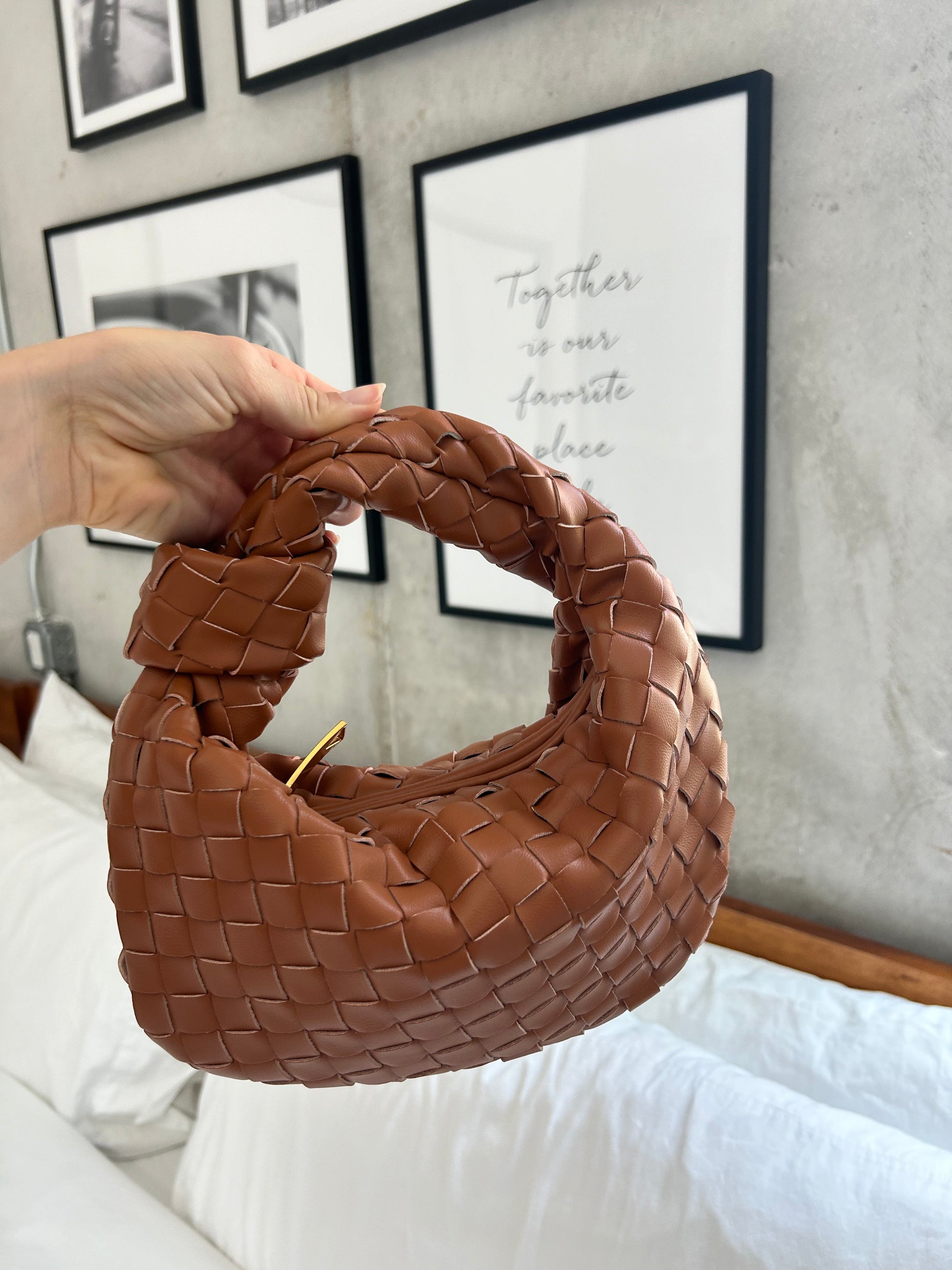 Crafted from high-quality vegan leather, this clutch features a large woven design that adds a touch of sophistication to any outfit. With its versatile style, this bag can be worn as a shoulder bag or a clutch. Designer dupe bag. Pattybofficial