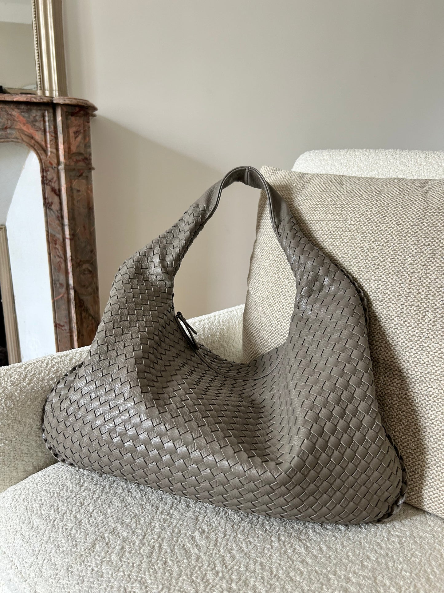Add a touch of elegance and style to your outfit with this trendy grey woven shoulder bag for women. This dumpling oversized purse is a must-have accessory for any fashion-forward individual, perfect for work (fits small laptop) or travelling. Designed to catch the eye of any trendsetter, this viral influencer bag is made from stylish vegan leather, offering both fashion and function. Stand out from the crowd with this chic and versatile purse that is sure to become your go-to for any event.
