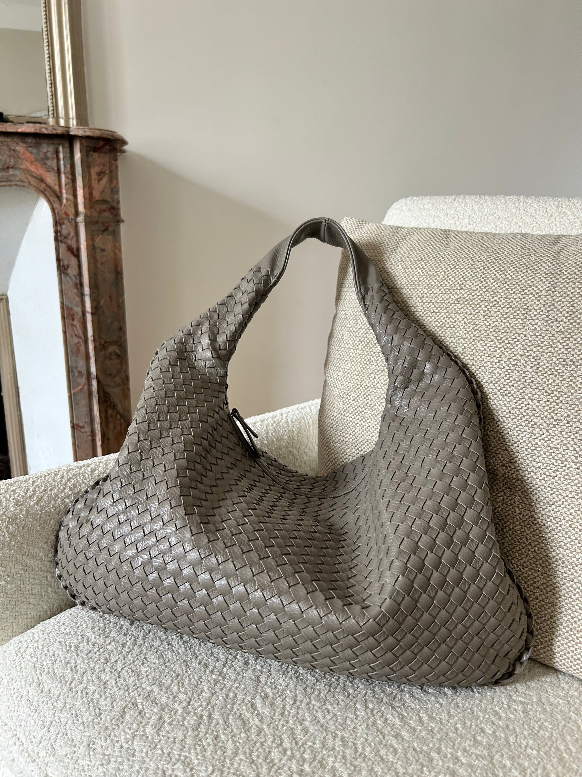Add a touch of elegance and style to your outfit with this trendy grey woven shoulder bag for women. This dumpling oversized purse is a must-have accessory for any fashion-forward individual, perfect for work (fits small laptop) or travelling. Designed to catch the eye of any trendsetter, this viral influencer bag is made from stylish vegan leather, offering both fashion and function. Stand out from the crowd with this chic and versatile purse that is sure to become your go-to for any event.
