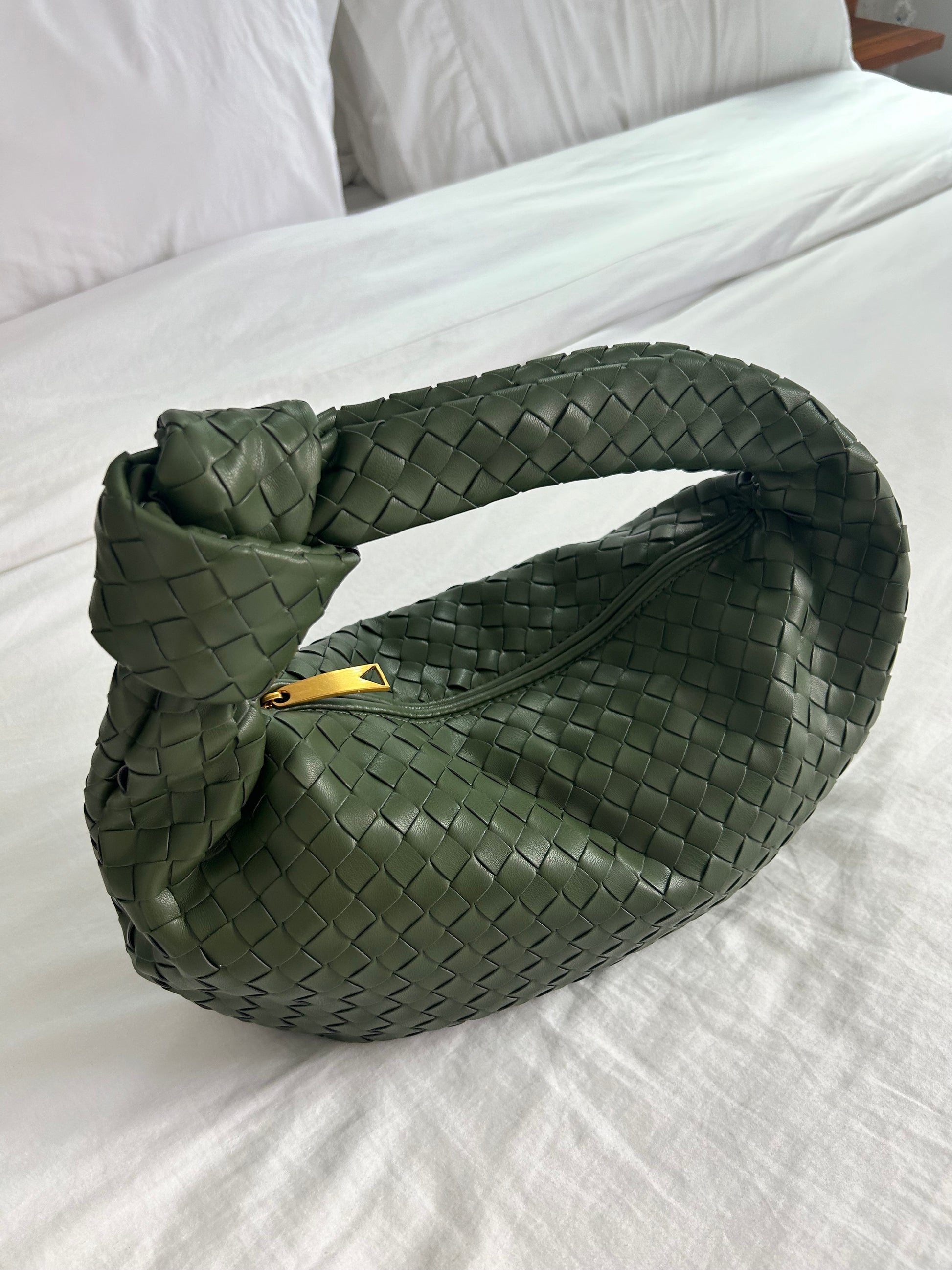 Introducing our exquisite and luxurious leather Clutch for wedding, a stunning accessory that will elevate any outfit with its elegance and sophistication. This woven Dumpling Bag is crafted from high-quality vegan leather. Designer inspired dupe bag