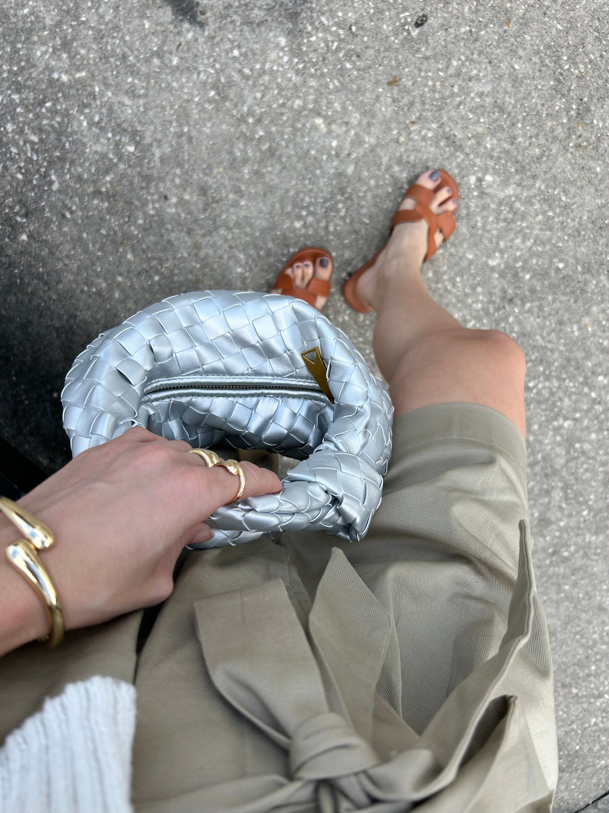 This braided pouch is the perfect gift for her – whether it's for a birthday, anniversary, holiday, or just because. Its timeless appeal suits all ages and fashion preferences, ensuring it will be a cherished addition to her wardrobe. The modern yet classic woven design and metallic finish make this a versatile handbag that pairs well with a variety of outfits, from sleek evening gowns to chic casual looks.