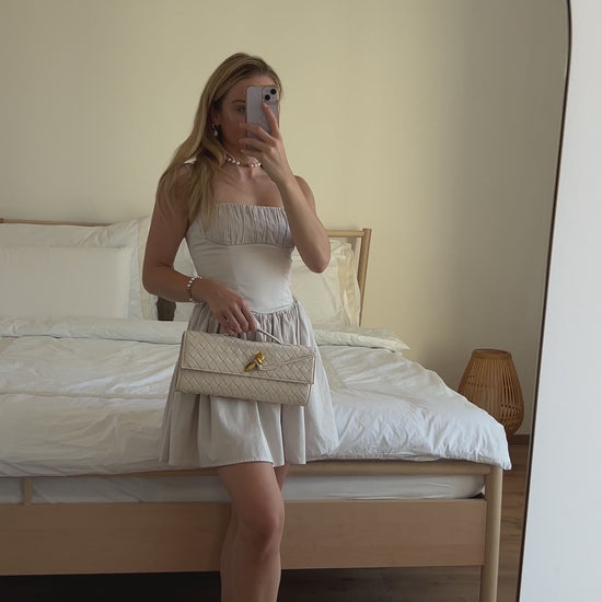 Women's cream vegan leather clutch for capsule wardrobe styling
