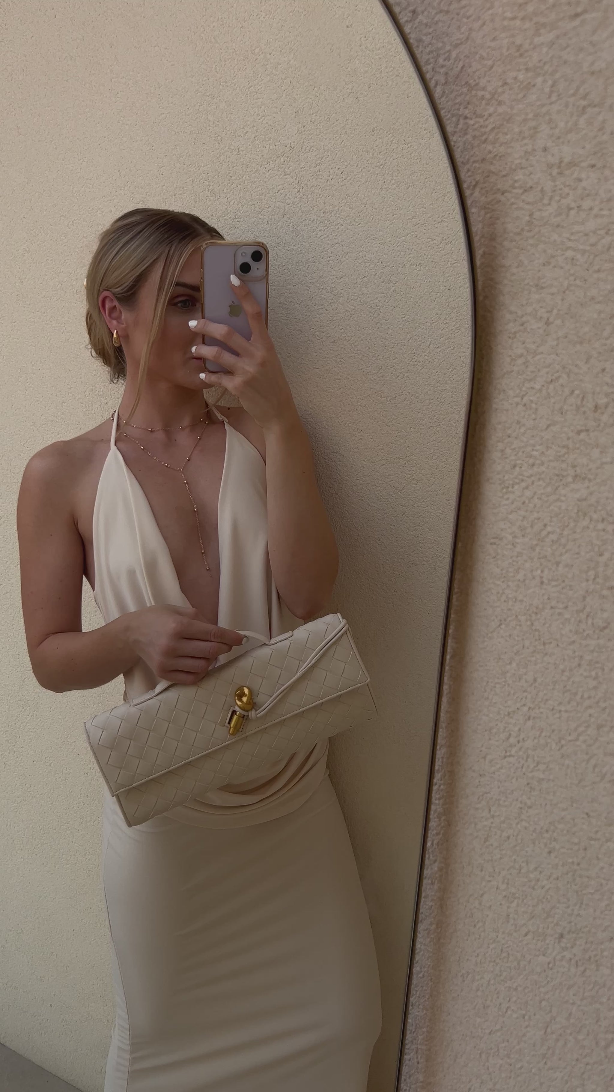Minimalist cream crossbody bag with woven texture and detachable strap