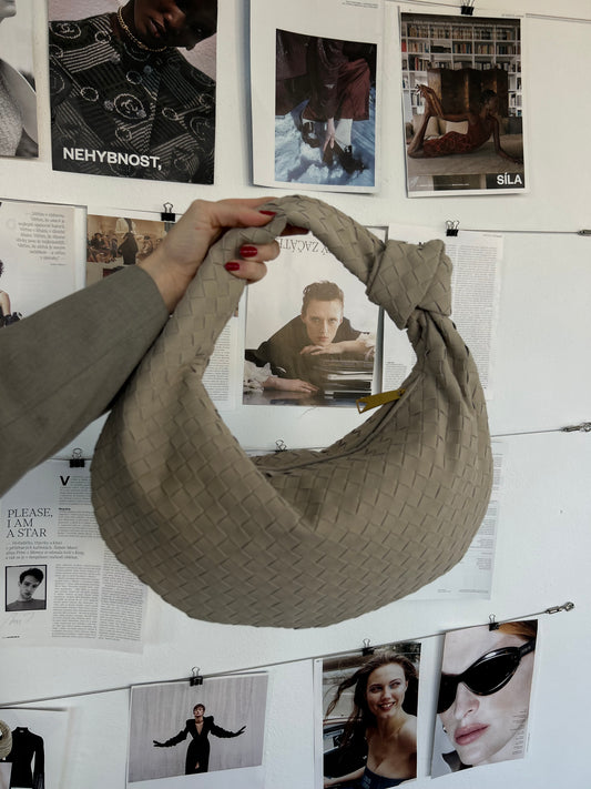 Introducing the Suede Design Woven Knot Bag by PattyB, a stylish and sustainable accessory that blends luxury with eco-conscious craftsmanship. This braided purse is designed for the fashion-forward woman, featuring a unique woven knot design that adds texture and depth to its sleek silhouette. Crafted from premium, eco-friendly materials, this bag is not only a beautiful accessory but also a responsible choice for those who value sustainability.