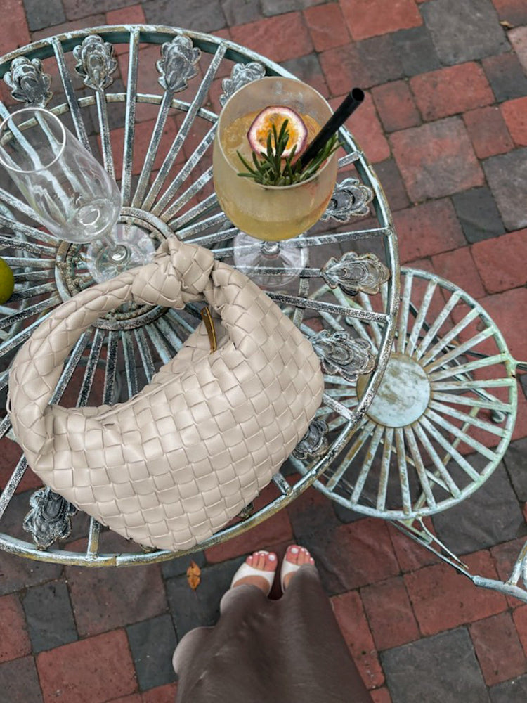 taupe woven knot bag with gold zip and triangle detail, inspired by designer