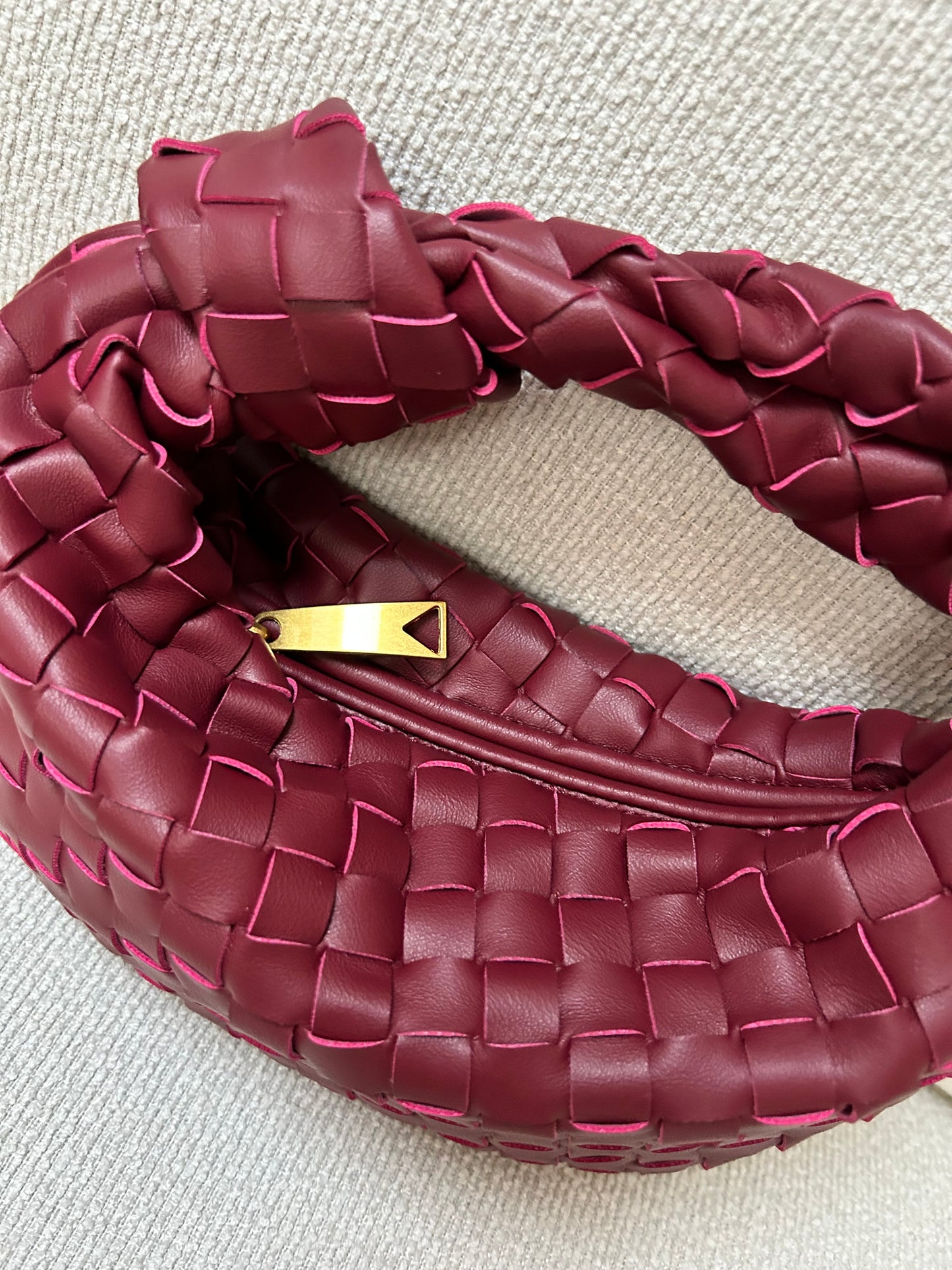 woven clutch bag with zip closure showing interior space for essentials phone keys makeup
